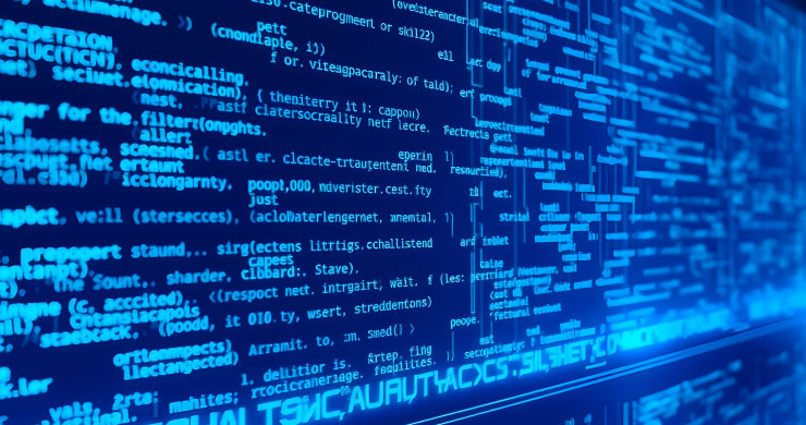 モニタに青く光る無数のプログラムコードを表示。生成AIによるコード生成・レビュー支援をイメージ。