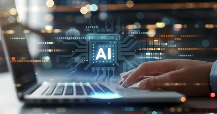 ノートパソコンを操作する人物の前に、白く光る「AI」の文字と未来的なパーツが浮かび上がっている様子。AIにおける活用人材の育成と業務改善のアイデアをイメージ